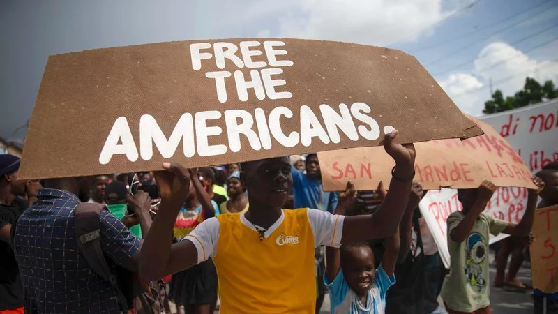 People protest for the release of kidnapped missionaries near the Ohio-based Christian Aid Ministries headquarters in Titanyen, north of Port-au-Prince, Haiti, on Oct. 19, 2021. A group of 17 U.S. missionaries including children was kidnapped by a gang in Haiti on Oct. 16, according to a voice message sent to various religious missions by an organization with direct knowledge of the incident. Photo courtesy of AP.